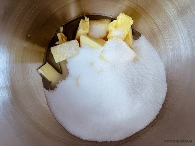 Softened butter, oil, and caster sugar in a stand mixer bowl before mixing.