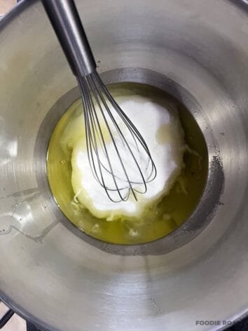 Egg whites and sugar in a heatproof mixing bowl with a whisk, ready to be heated over a bain-marie.