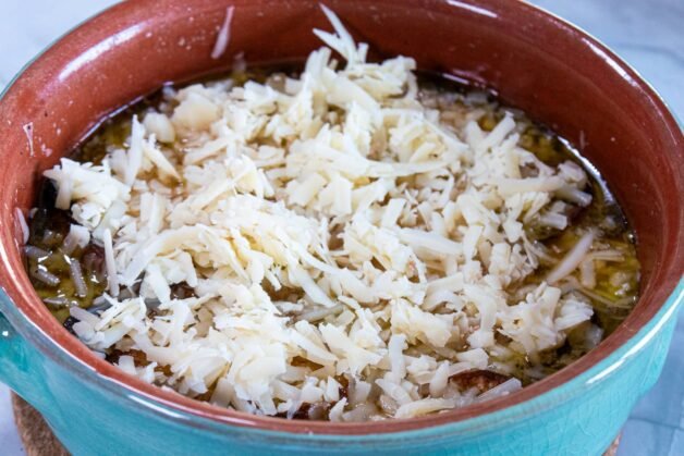 French onion soup topped with grated Gruyère cheese before broiling.