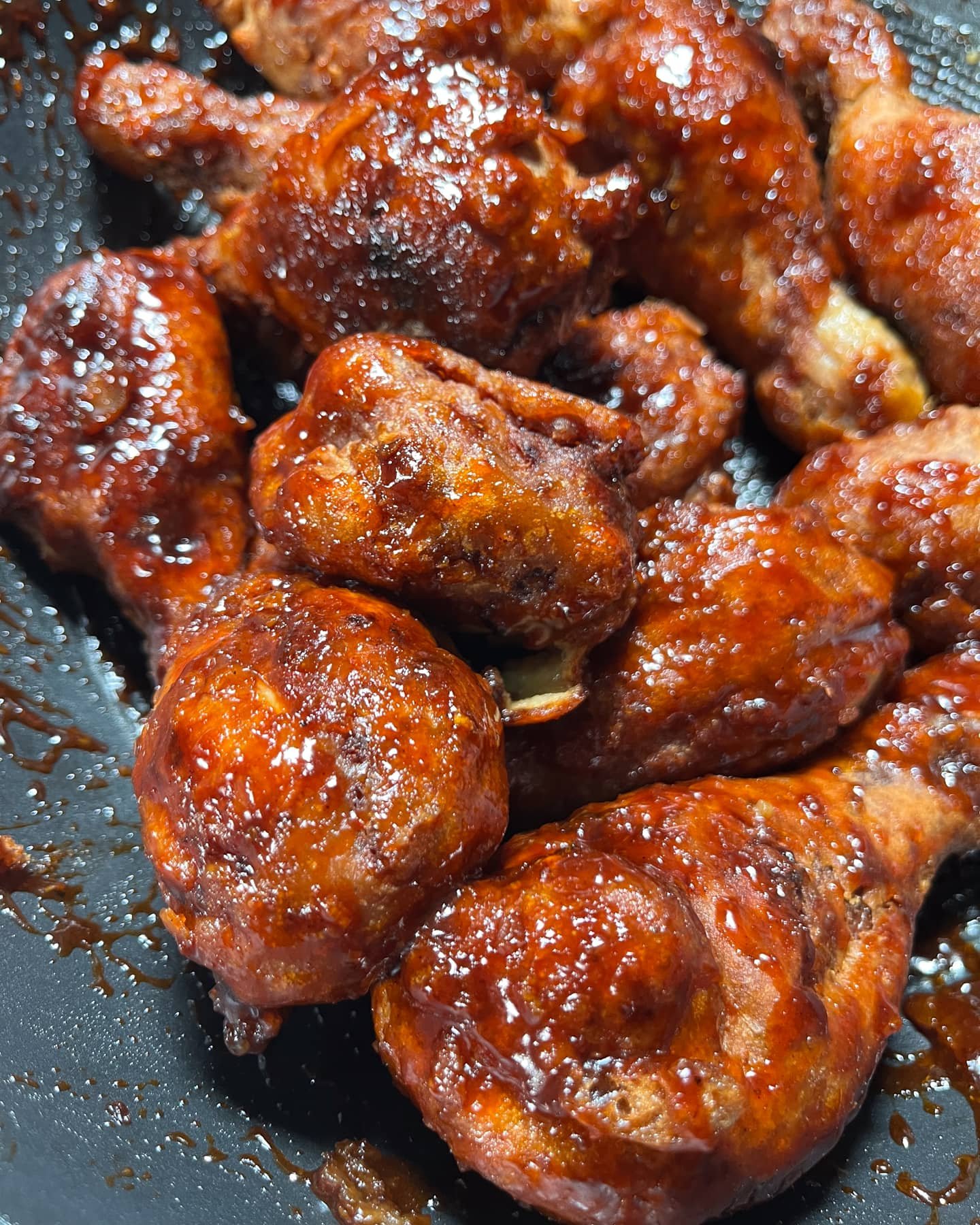 Glazed Korean fried chicken drumsticks coated in a glossy Yangnyeom sauce.