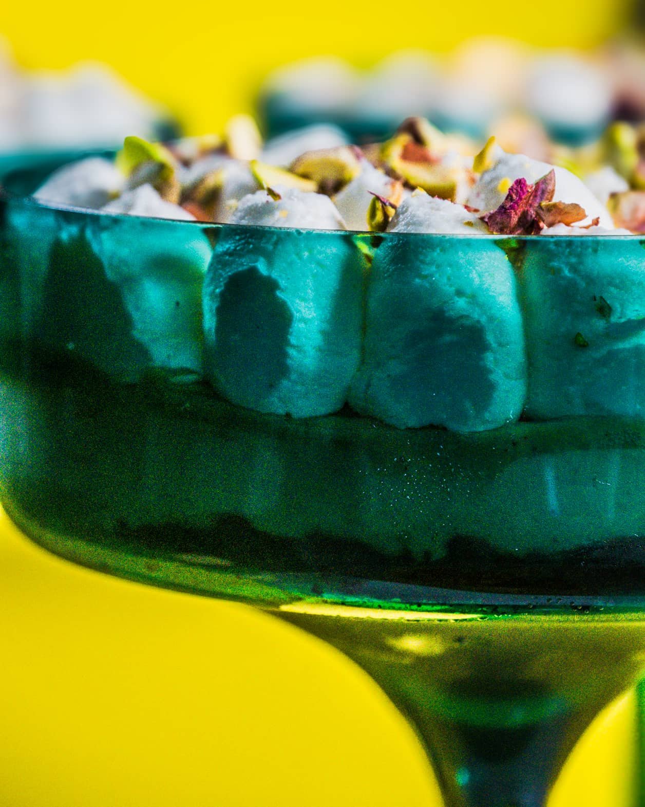 A close-up side view of Pistachio Delight Dessert Cups, showing distinct dessert layers.