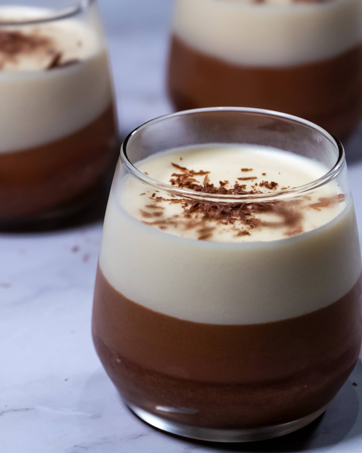 Triple Chocolate Mousse with dark, milk, and white chocolate layers, topped with chocolate shavings.